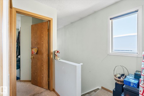 Hallway with an upstairs landing, carpet floors, and a textured ceiling - 15035 133 Street, Edmonton, AB - Indoor Photo Showing Other Room
