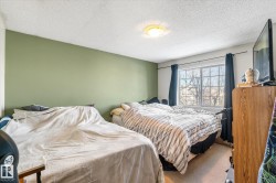 Bedroom featuring carpet and a textured ceiling - 