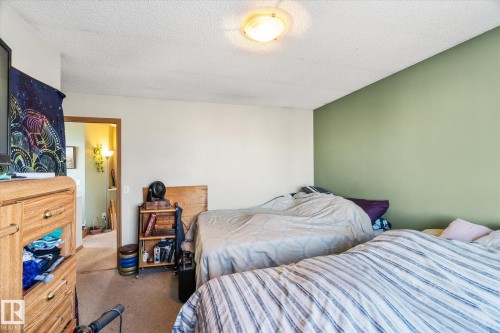 Carpeted bedroom featuring a textured ceiling - 15035 133 Street, Edmonton, AB - Indoor Photo Showing Bedroom