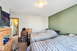 Carpeted bedroom featuring a textured ceiling - 