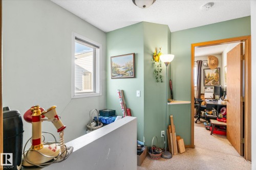 Hallway with a textured ceiling and carpet - 15035 133 Street, Edmonton, AB - Indoor Photo Showing Other Room