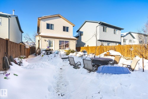 Snow covered house featuring a fenced backyard - 15035 133 Street, Edmonton, AB - Outdoor