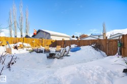 Snowy yard featuring a fenced backyard - 