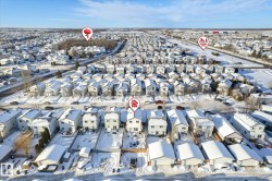 Aerial view of property and surrounding area featuring nearby suburban area - 