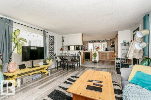 Living area featuring wood finished floors and a textured ceiling - 216 53222 Rge Rd 272, Rural Parkland County, AB - Indoor Photo Showing Living Room