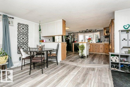 Dining space with a textured ceiling, light wood-type flooring, and track lighting - 216 53222 Rge Rd 272, Rural Parkland County, AB - Indoor Photo Showing Dining Room