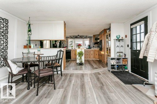 Dining area featuring a textured ceiling, light wood finished floors, and healthy amount of natural light - 216 53222 Rge Rd 272, Rural Parkland County, AB - Indoor Photo Showing Dining Room