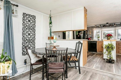 Dining space with a textured ceiling and light wood-type flooring - 216 53222 Rge Rd 272, Rural Parkland County, AB - Indoor Photo Showing Dining Room