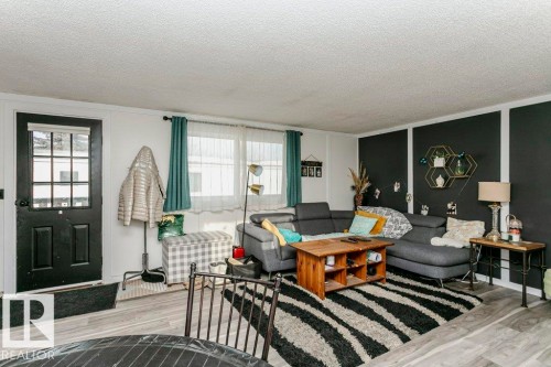 Living room with a textured ceiling and wood finished floors - 216 53222 Rge Rd 272, Rural Parkland County, AB - Indoor