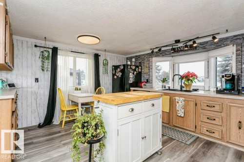 Kitchen with wood counters, freestanding refrigerator, white cabinets, light wood-style floors, and a textured ceiling - 216 53222 Rge Rd 272, Rural Parkland County, AB - Indoor Photo Showing Kitchen