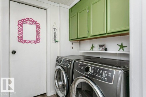 Laundry room featuring cabinet space and separate washer and dryer - 216 53222 Rge Rd 272, Rural Parkland County, AB - Indoor Photo Showing Laundry Room