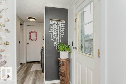 Doorway to outside with a textured ceiling and wood finished floors - 216 53222 Rge Rd 272, Rural Parkland County, AB - Indoor Photo Showing Other Room
