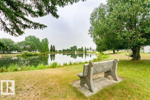 View of community featuring a water view and a lawn - 216 53222 Rge Rd 272, Rural Parkland County, AB - Outdoor