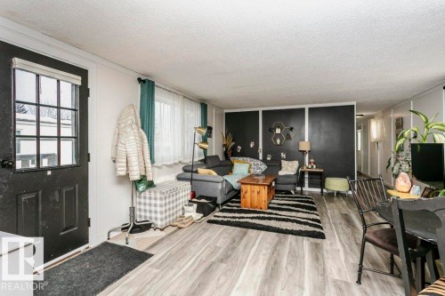 Living room with a textured ceiling and wood finished floors - 216 53222 Rge Rd 272, Rural Parkland County, AB - Indoor