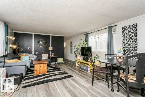 Living area with wood finished floors and a textured ceiling - 216 53222 Rge Rd 272, Rural Parkland County, AB - Indoor Photo Showing Living Room