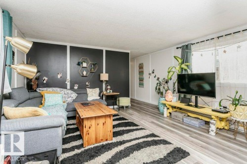 Living area with light wood-type flooring and a textured ceiling - 216 53222 Rge Rd 272, Rural Parkland County, AB - Indoor Photo Showing Living Room