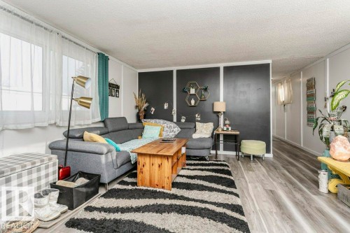 Living room featuring wood finished floors and a textured ceiling - 216 53222 Rge Rd 272, Rural Parkland County, AB - Indoor Photo Showing Other Room