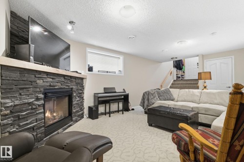 22 Lamplight Bay, Spruce Grove, AB - Indoor Photo Showing Living Room With Fireplace