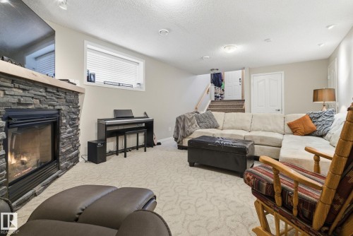 22 Lamplight Bay, Spruce Grove, AB - Indoor Photo Showing Living Room With Fireplace