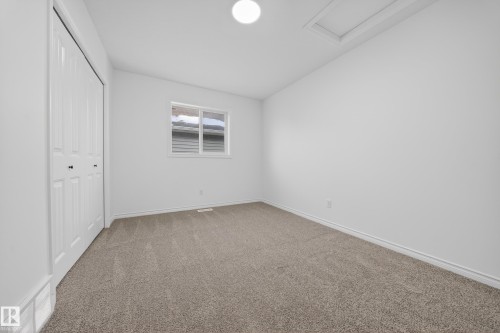 Unfurnished bedroom with light carpet, a closet, and vaulted ceiling - 1741 63A Street, Edmonton, AB - Indoor Photo Showing Other Room