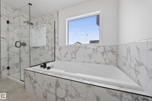 Full bathroom featuring a bath and a marble finish shower - 1741 63A Street, Edmonton, AB - Indoor Photo Showing Bathroom