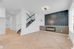 Unfurnished living room with stairs and a fireplace - 