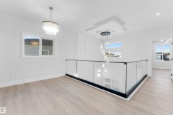 Unfurnished dining area featuring light wood-type flooring and a chandelier - 