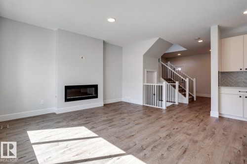 405 Brickyard Point(E), Stony Plain, AB - Indoor Photo Showing Living Room With Fireplace