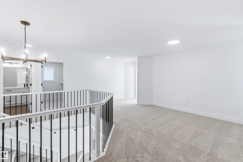 Hall with a chandelier, light colored carpet, and recessed lighting - 2211 4 Avenue, Edmonton, AB - Indoor Photo Showing Other Room