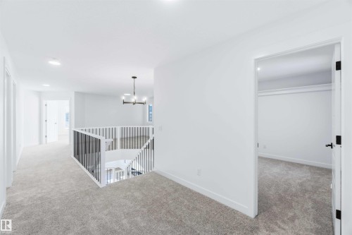 Hallway featuring light carpet, an upstairs landing, and recessed lighting - 2211 4 Avenue, Edmonton, AB - Indoor Photo Showing Other Room