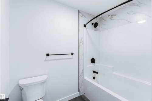 Full bathroom featuring shower / bath combination and toilet - 2211 4 Avenue, Edmonton, AB - Indoor Photo Showing Bathroom