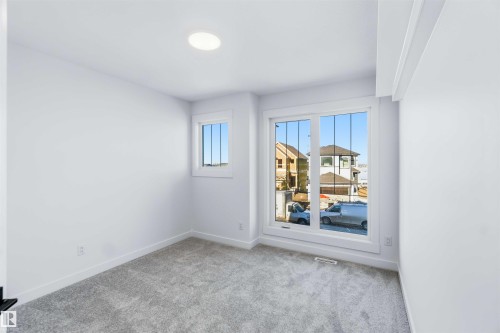 Spare room featuring carpet flooring and baseboards - 2211 4 Avenue, Edmonton, AB - Indoor Photo Showing Other Room