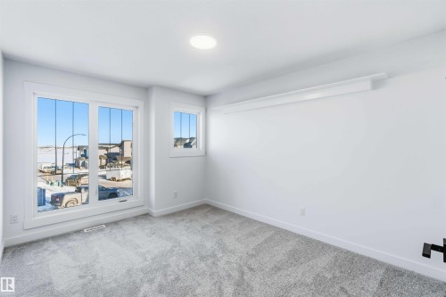 Empty room with carpet flooring and baseboards - 2211 4 Avenue, Edmonton, AB - Indoor Photo Showing Other Room