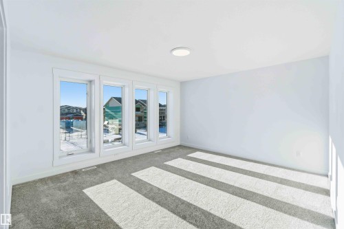 Unfurnished room with carpet flooring and baseboards - 2211 4 Avenue, Edmonton, AB - Indoor Photo Showing Other Room