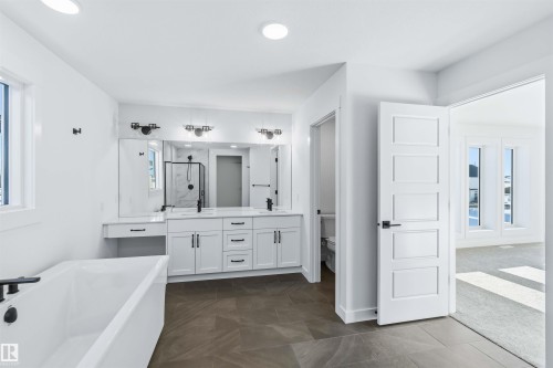 Bathroom with a soaking tub, double vanity, a marble finish shower, and recessed lighting - 2211 4 Avenue, Edmonton, AB - Indoor Photo Showing Other Room