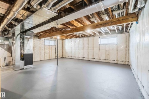 Basement with healthy amount of natural light and heating unit - 2211 4 Avenue, Edmonton, AB - Indoor Photo Showing Basement