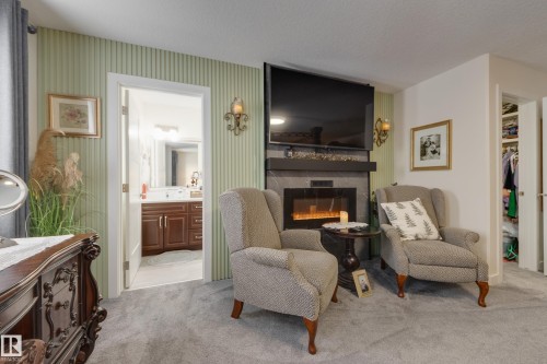 64 Maple Crescent, Gibbons, AB - Indoor Photo Showing Living Room With Fireplace