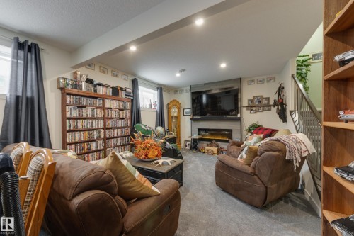 64 Maple Crescent, Gibbons, AB - Indoor Photo Showing Living Room With Fireplace