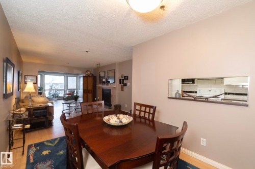 Dining space featuring light wood-type flooring and a textured ceiling - 203 10171 119 Street Nw, Edmonton, AB - Indoor Photo Showing Dining Room