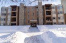 Snow covered building featuring a view of apartment building / complex - 203 10171 119 Street Nw, Edmonton, AB  - Outdoor With Facade 