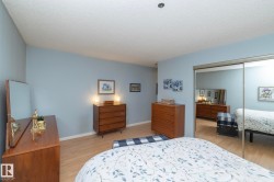 Bedroom featuring a textured ceiling, light wood-type flooring, and a closet - 