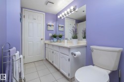 Full bathroom featuring vanity, light tile patterned floors, and a shower with curtain - 