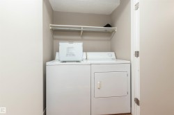 Laundry area with a textured ceiling and washing machine and clothes dryer - 