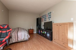 Bedroom with a textured ceiling and wood finished floors - 