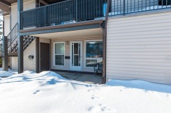 Snow covered property entrance featuring a patio area - 