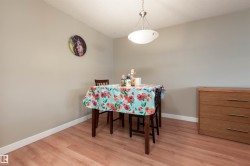 Dining space with light wood-type flooring and a textured ceiling - 