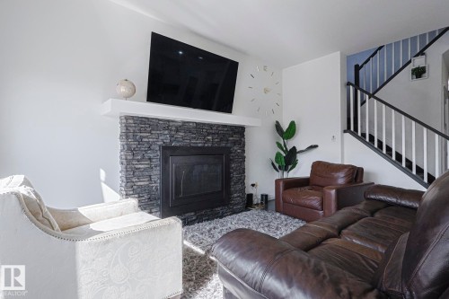 720 Charlesworth Way, Edmonton, AB - Indoor Photo Showing Living Room With Fireplace