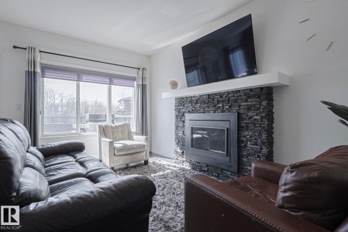 720 Charlesworth Way, Edmonton, AB - Indoor Photo Showing Living Room With Fireplace