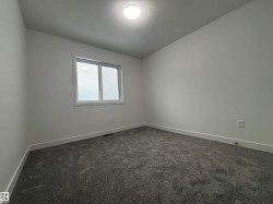 Empty room with dark carpet and baseboards - 