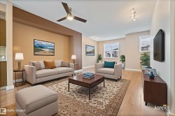Living area with ceiling fan and light wood-type flooring - 